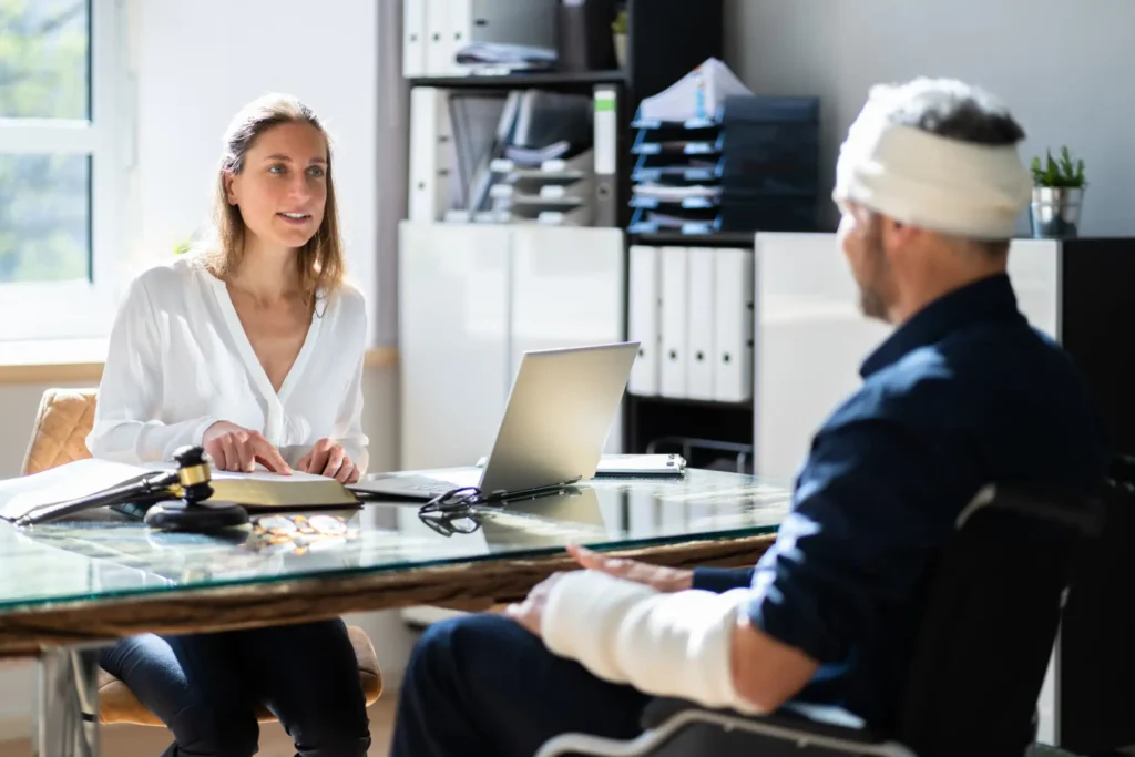 Attorney and client reviewing accident photos—how much does a lawyer cost for a car accident contingency discussion